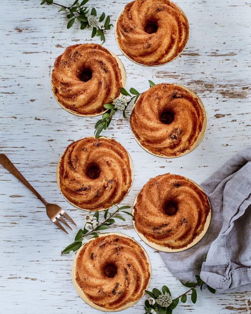 Six individual rum cakes from company Bayard Royal from Montreal Canada on a white washed table .